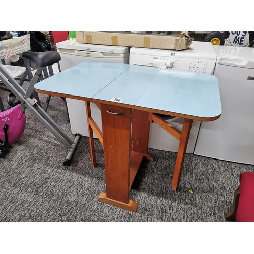 508 - Drop leaf 1970's blue formica topped table in overall good condition height 76cm, 90cm wide with lea... 