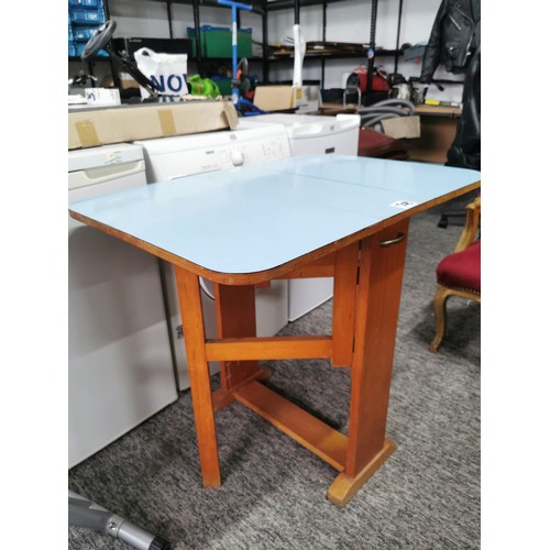 508 - Drop leaf 1970's blue formica topped table in overall good condition height 76cm, 90cm wide with lea... 