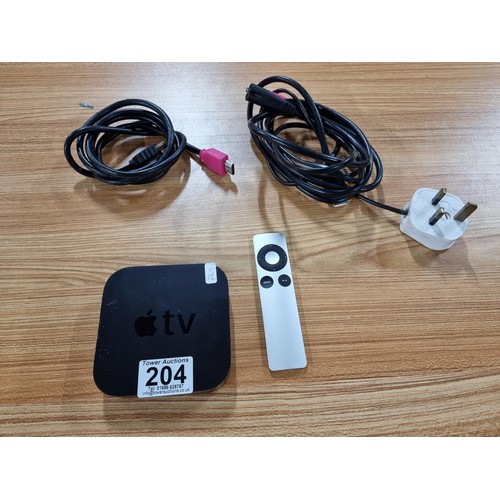 204 - An apple tv box complete with its remote and HD cables.