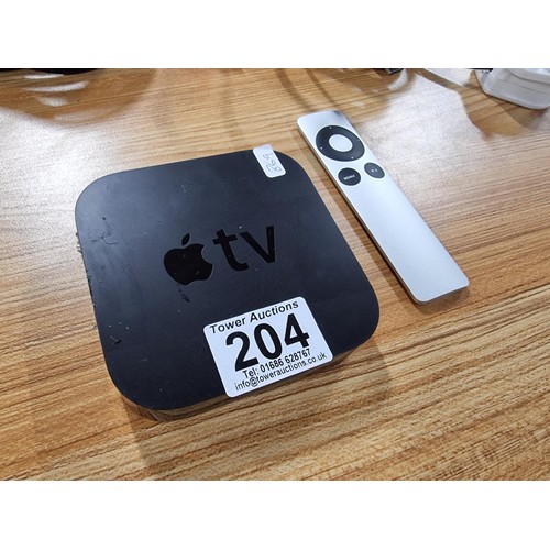 204 - An apple tv box complete with its remote and HD cables.