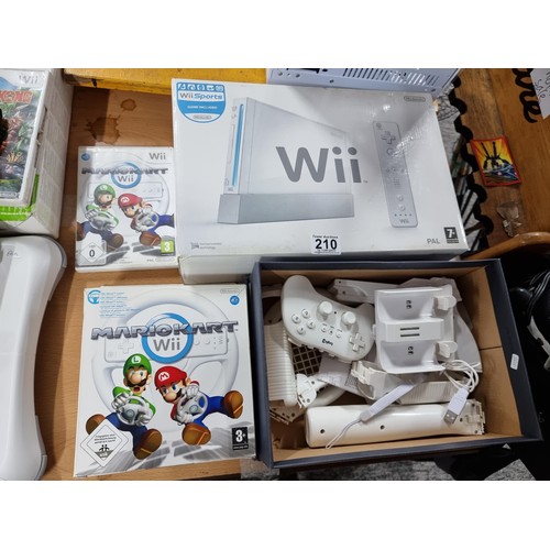 210 - A boxed Nintendo Wii games console along with a Mario Kart game and steering wheel, also a bundle of... 