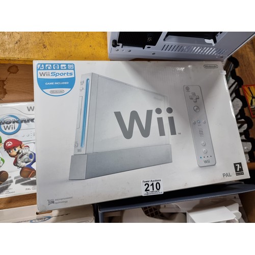 210 - A boxed Nintendo Wii games console along with a Mario Kart game and steering wheel, also a bundle of... 