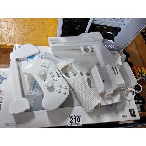 210 - A boxed Nintendo Wii games console along with a Mario Kart game and steering wheel, also a bundle of... 