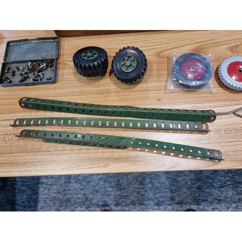 240 - A box containing a large quantity of vintage Meccano to include some rare pieces, please study the p... 