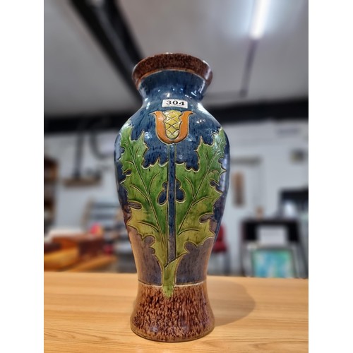 253 - A large antique impressive Belgian glazed vase featuring an incised art nouveau thistle design, made... 