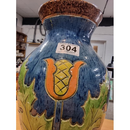 253 - A large antique impressive Belgian glazed vase featuring an incised art nouveau thistle design, made... 