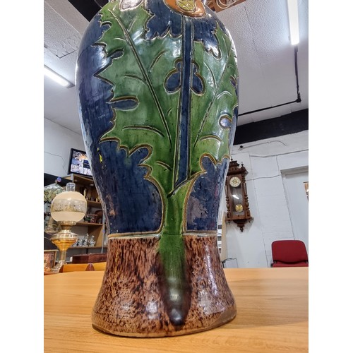 253 - A large antique impressive Belgian glazed vase featuring an incised art nouveau thistle design, made... 