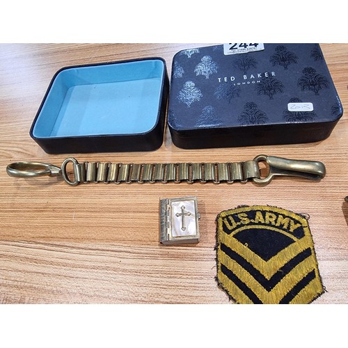 244 - A box containing a quantity of collectables to include a miniature bible and heavy duty brass chain ... 