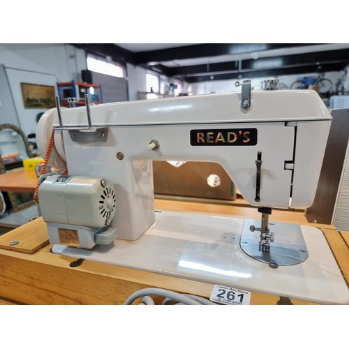 261 - A good quality Read's model 300 sewing machine complete with its foot pedal, original case, and orig... 