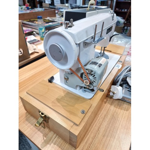 261 - A good quality Read's model 300 sewing machine complete with its foot pedal, original case, and orig... 
