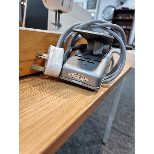 261 - A good quality Read's model 300 sewing machine complete with its foot pedal, original case, and orig... 
