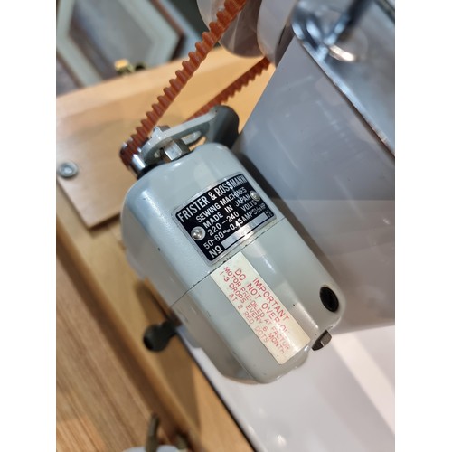 261 - A good quality Read's model 300 sewing machine complete with its foot pedal, original case, and orig... 