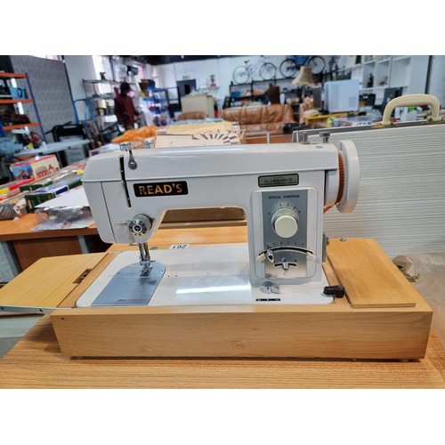 261 - A good quality Read's model 300 sewing machine complete with its foot pedal, original case, and orig... 