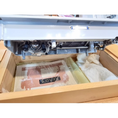 261 - A good quality Read's model 300 sewing machine complete with its foot pedal, original case, and orig... 