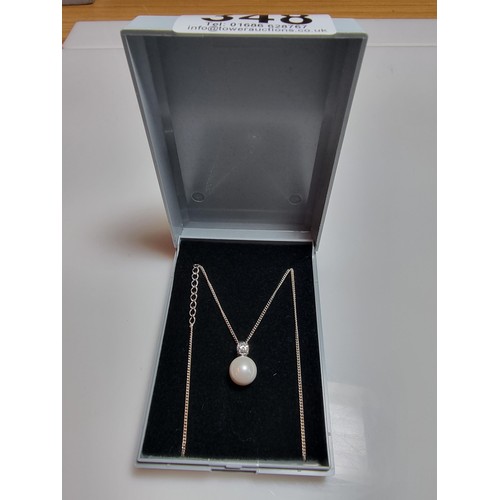 308 - A 925 silver faux pearl pendant with a CZ crystal stone set on an 18