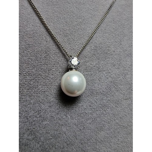 308 - A 925 silver faux pearl pendant with a CZ crystal stone set on an 18
