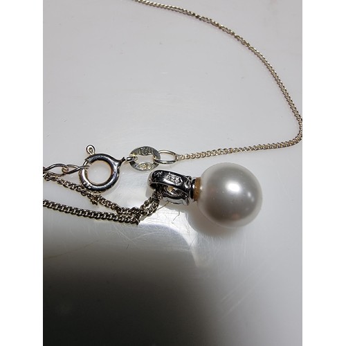 308 - A 925 silver faux pearl pendant with a CZ crystal stone set on an 18
