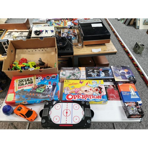 275 - A box of toys and games, many are unopened, to include a small air hockey game, various action figur... 