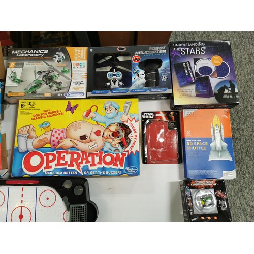 275 - A box of toys and games, many are unopened, to include a small air hockey game, various action figur... 