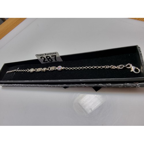 287 - A 925 silver bracelet with a start charm and enamel hart charms in good clean condition, boxed. Tota... 