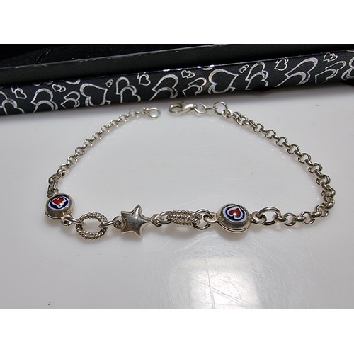 287 - A 925 silver bracelet with a start charm and enamel hart charms in good clean condition, boxed. Tota... 