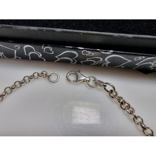 287 - A 925 silver bracelet with a start charm and enamel hart charms in good clean condition, boxed. Tota... 