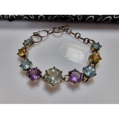 288 - A pretty 925 silver multi gemstone bracelet inset with real quartz, amethyst, topaz, and citrine, in... 