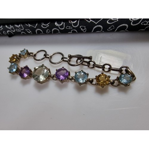 288 - A pretty 925 silver multi gemstone bracelet inset with real quartz, amethyst, topaz, and citrine, in... 