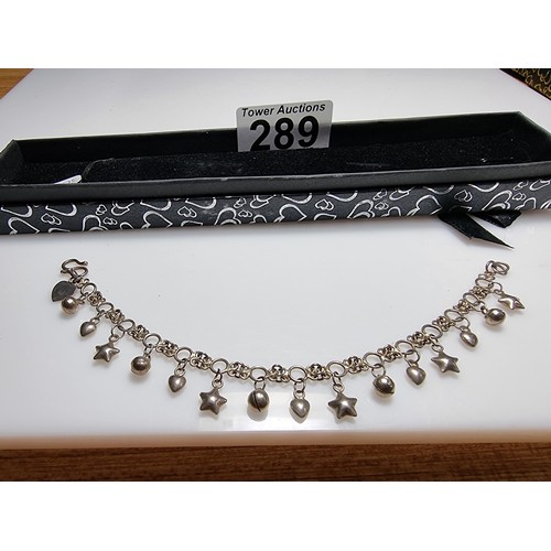 289 - A 925 silver bracelet with star, heart and bell charms, in clean condition and boxed. Length 7