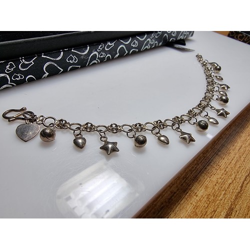 289 - A 925 silver bracelet with star, heart and bell charms, in clean condition and boxed. Length 7