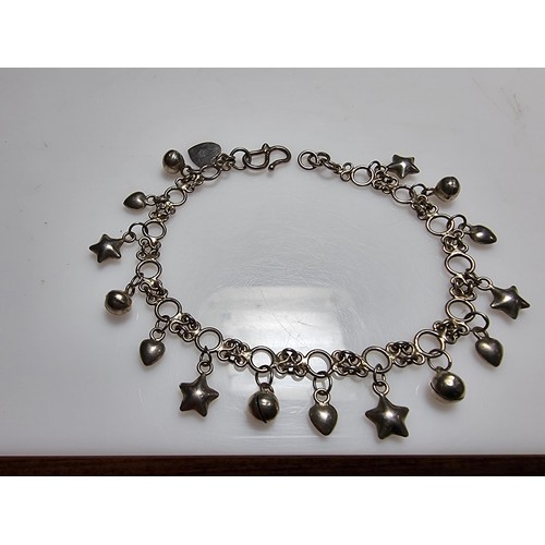 289 - A 925 silver bracelet with star, heart and bell charms, in clean condition and boxed. Length 7