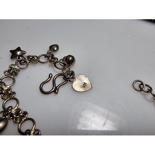 289 - A 925 silver bracelet with star, heart and bell charms, in clean condition and boxed. Length 7