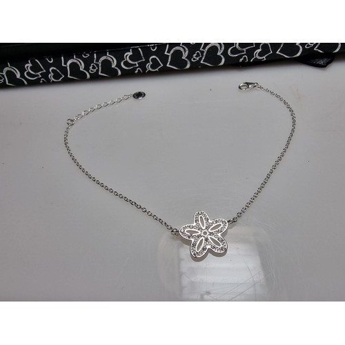 290 - A 925 silver bracelet with a flower charm inset with 15 small diamonds by Katie Loxton, in clean con... 