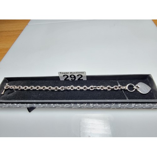 292 - A good quality chunky 925 silver bracelet with a silver charm to one end and a T bar to the other. I... 