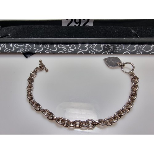 292 - A good quality chunky 925 silver bracelet with a silver charm to one end and a T bar to the other. I... 