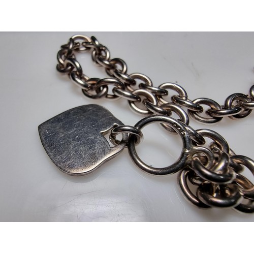 292 - A good quality chunky 925 silver bracelet with a silver charm to one end and a T bar to the other. I... 