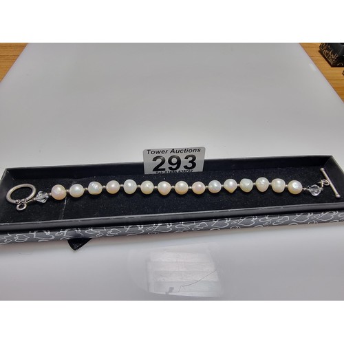 293 - A 925 silver, real pearl bracelet with glass charms to the end. In clean condition, boxed, length of... 