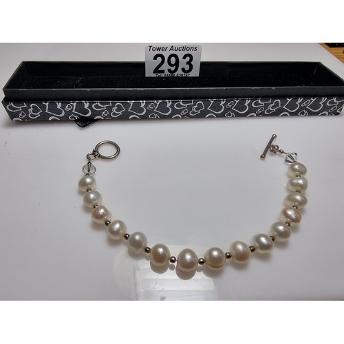 293 - A 925 silver, real pearl bracelet with glass charms to the end. In clean condition, boxed, length of... 