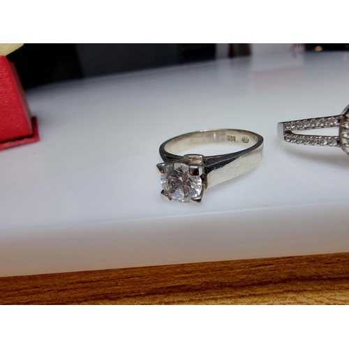 298 - 2x ornate 925 silver dress rings to include a solitaire style ring inset with a sparkly CZ crystal s... 