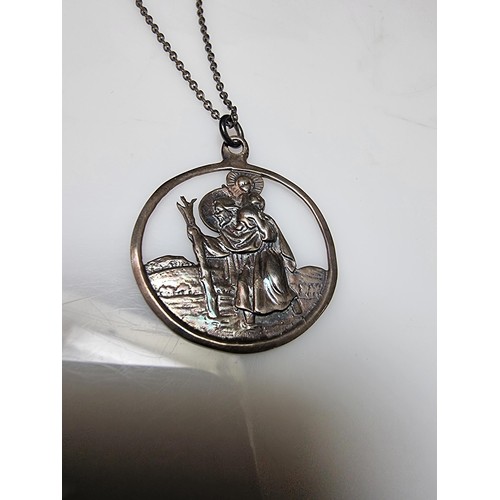 306 - A 925 silver St Christopher pendant on a long 20