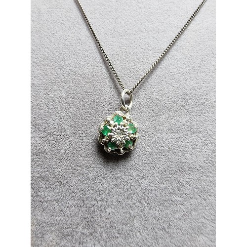 310 - A pretty 925 silver pendant inset with 5 emerald stones and a diamond to the centre on an 18