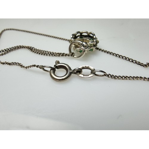 310 - A pretty 925 silver pendant inset with 5 emerald stones and a diamond to the centre on an 18