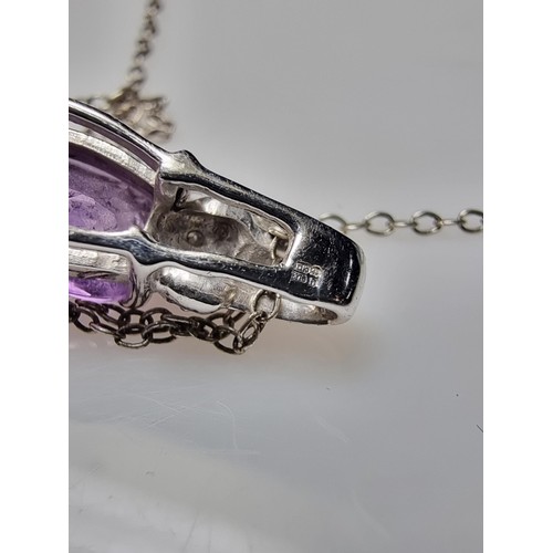 312 - A hallmarked 9ct white gold pendant inset with a large Amethyst gemstones and 2 diamonds set on an 1... 