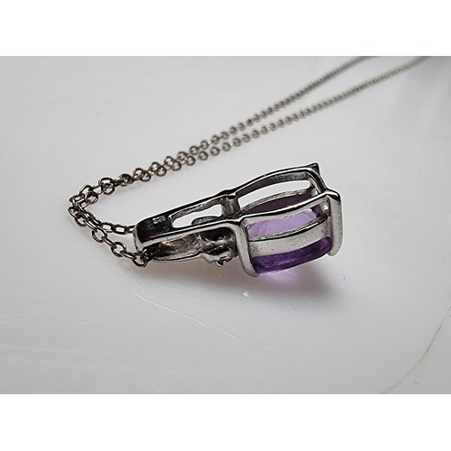 312 - A hallmarked 9ct white gold pendant inset with a large Amethyst gemstones and 2 diamonds set on an 1... 