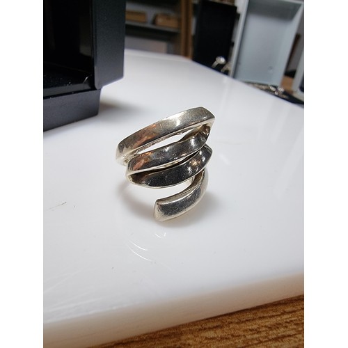 317 - A 925 silver ring with a fluid design, in clean condition and boxed, marked 925. Size L.