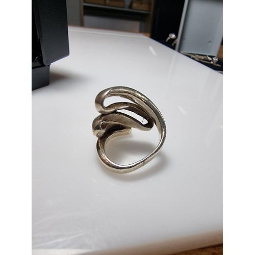 317 - A 925 silver ring with a fluid design, in clean condition and boxed, marked 925. Size L.