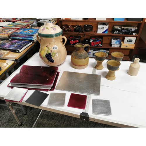 286 - A box containing a quantity of crockery and placemats inc a large lidded Rumpot, earthenware jug wit... 