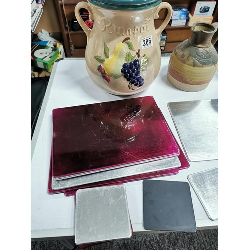 286 - A box containing a quantity of crockery and placemats inc a large lidded Rumpot, earthenware jug wit... 