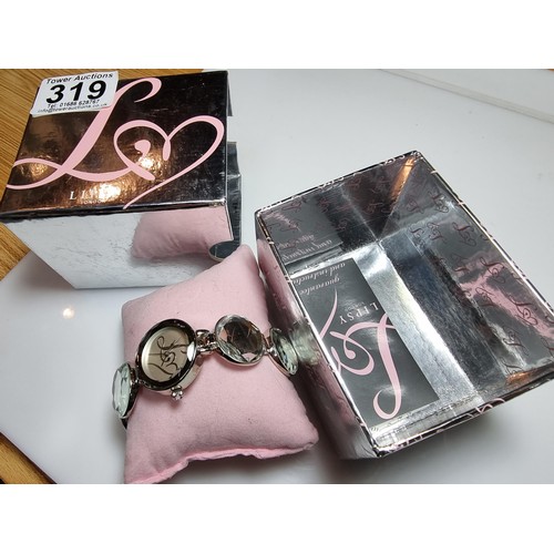 319 - A boxed unused Lipsy London ladies watch with a mirrored style strap.