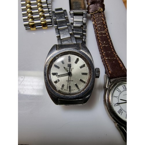 321 - A quantity of watches along with a quantity of costume earrings to include a a genuine Tissot sea st... 